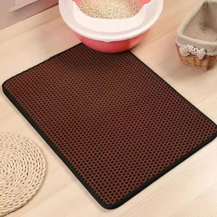 Brown litter honeycomb mat on a light wooden floor with pet accessories in the background