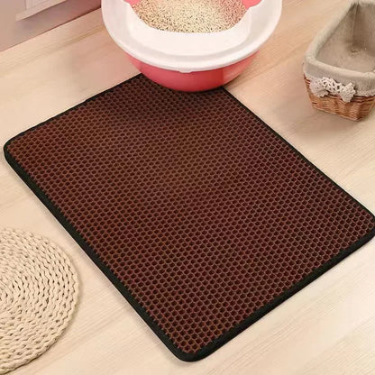 Brown litter honeycomb mat on a light wooden floor with pet accessories in the background